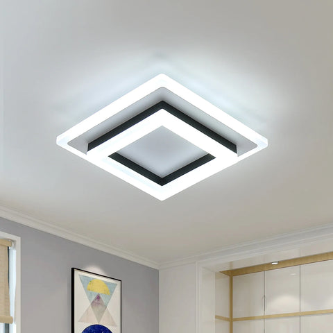 Modern ceiling light fixture in a room with neutral walls and decor.