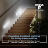 Stairwell with wall-mounted lights and 'moss & stone' branding.