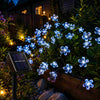 Blue solar-powered waterproof fairy garden string lights by Solightify, ideal for outdoor garden illumination and decoration.