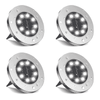 Set of four Solightify outdoor waterproof solar deck lights with cool white LED illumination, designed for ground or driveway installation.
