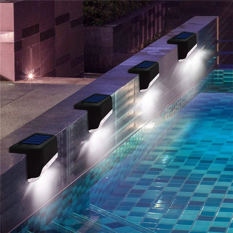 Set of four Solightify waterproof solar decking lights illuminating garden pathways for winter use.