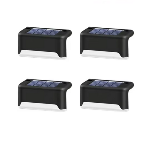 Set of four Solightify waterproof solar decking lights illuminating outdoor garden pathways at night.