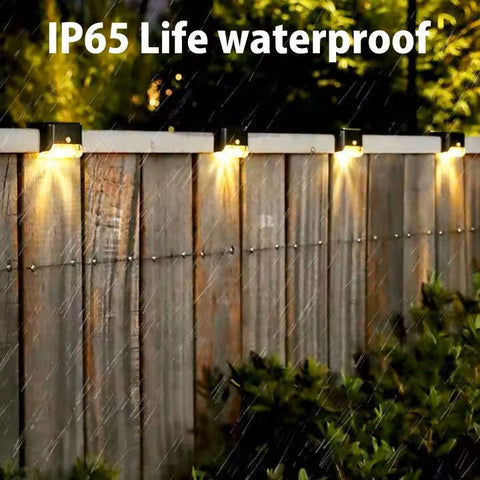 Set of four waterproof Solightify solar decking lights illuminating garden paths, ideal for winter outdoor decorating.