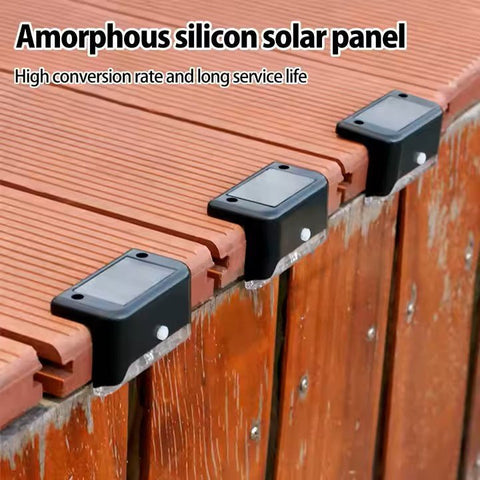 Set of four Solightify waterproof solar decking lights illuminating garden pathways, ideal for winter outdoor lighting.