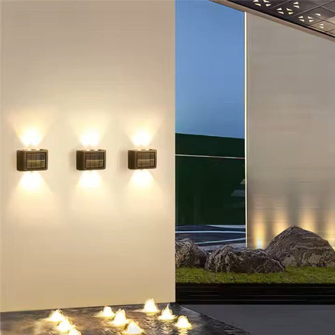Two Solightify solar garden spot lights with waterproof up and down design, warm white light, and sensor for outdoor wall illumination.