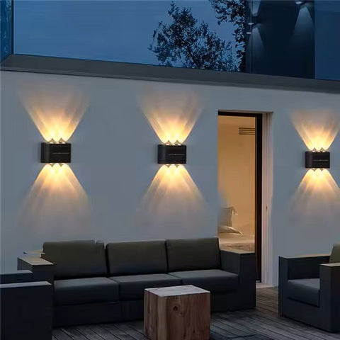 Two Solightify solar garden spot lights with waterproof up and down design, sensor, and warm white illumination for outdoor walls.