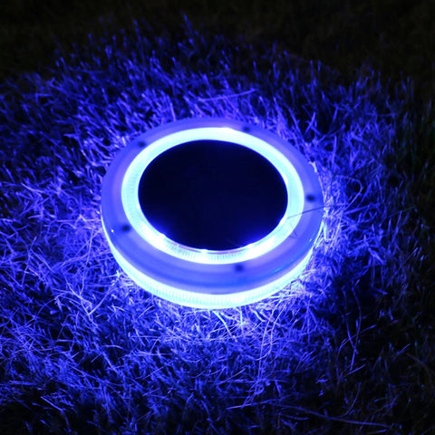 Solightify solar floating pool light illuminating a swimming pool with a colorful glow at night.