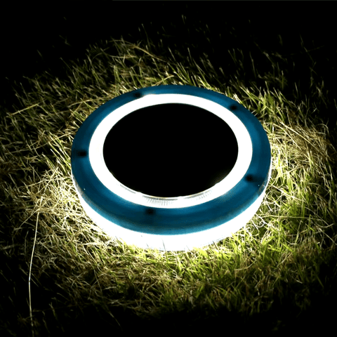 Solightify solar floating pool light illuminating a swimming pool with a sleek, round design and vibrant glow at night.